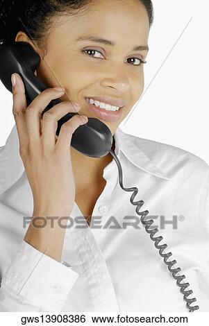 Portrait of a businesswoman talking on the telephone View Large Photo Image Stock Photograph - Portrait of a businesswoman talking on the telephone. Fotosearch