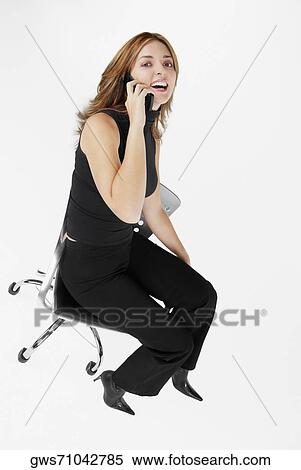 Portrait of a businesswoman talking on a mobile phone and laughing View Large Photo Image Stock Photography - Portrait of a businesswoman talking on a mobile phone and laughing. Fotosearch