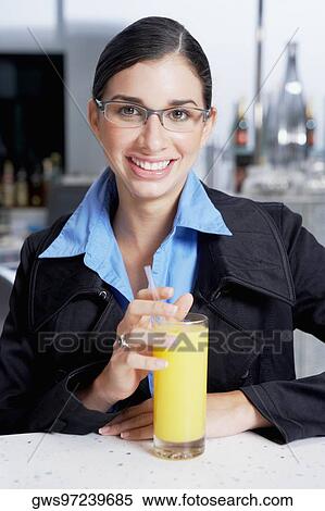 Portrait of a businesswoman with a glass of orange juice View Large Photo Image Stock Photography - Portrait of a businesswoman with a glass of orange juice. Fotosearch