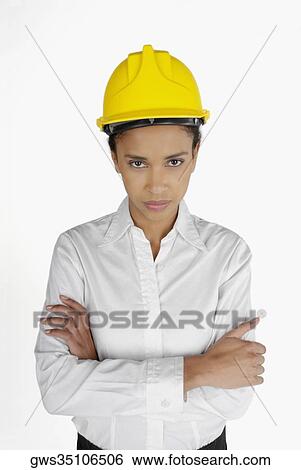 Stock Photograph - Portrait of a female architect standing with her arms folded. Fotosearch