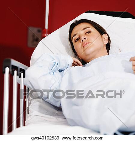 Portrait of a female patient lying on the hospital gurney in a hospital ward View Large Photo Image Stock Photo - Portrait of a female patient lying on the hospital gurney in a hospital ward. Fotosearch