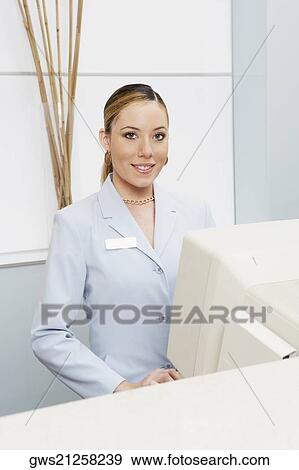 Portrait of a female receptionist in front of a computer View Large Photo Image Stock Photo - Portrait of a female receptionist in front of a computer. Fotosearch