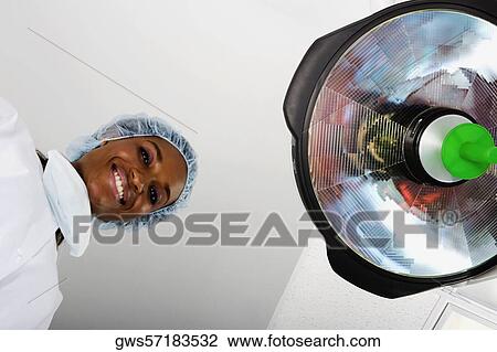 Portrait of a female surgeon smiling View Large Photo Image Stock Image - Portrait of a female surgeon smiling. Fotosearch