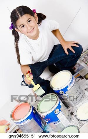 Portrait of a girl holding a paintbrush over a paint can View Large Photo Image Stock Image - Portrait of a girl holding a paintbrush over a paint can. Fotosearch