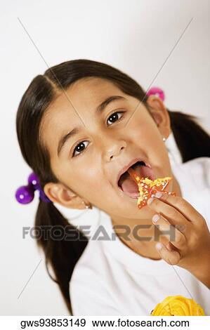Stock Photo - Portrait of a girl licking a candy. Fotosearch