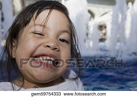 Portrait of a girl making a face at the poolside View Large Photo Image Stock Image - Portrait of a girl making a face at the poolside. Fotosearch