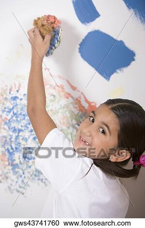 Portrait of a girl painting a wall with a sponge View Large Photo Image Stock Image - Portrait of a girl painting a wall with a sponge. Fotosearch