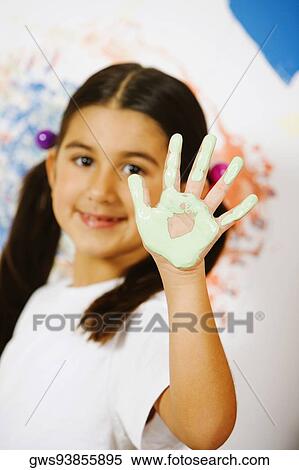 Stock Photography - Portrait of a girl showing paint on her palm. Fotosearch