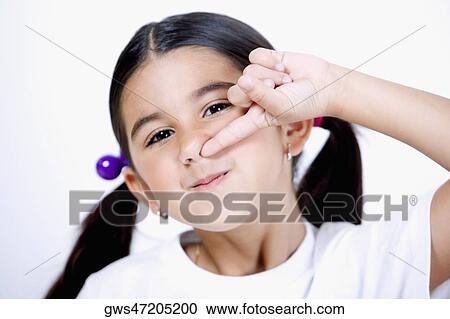 Stock Image - Portrait of a girl with her finger in her nose. Fotosearch