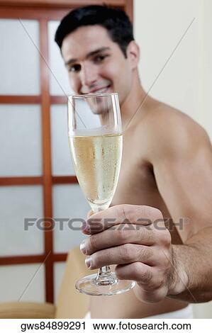 Portrait of a groom holding a champagne flute View Large Photo Image Stock Image - Portrait of a groom holding a champagne flute. Fotosearch