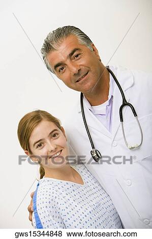 Portrait of a male doctor and a young woman smiling View Large Photo Image Stock Photo - Portrait of a male doctor and a young woman smiling. Fotosearch