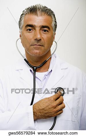 Portrait of a male doctor examining himself with a stethoscope View Large Photo Image Picture - Portrait of a male doctor examining himself with a stethoscope. Fotosearch