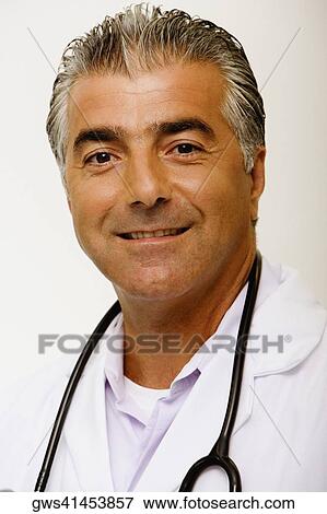 Stock Photo - Portrait of a male doctor with a stethoscope around his neck and smiling. Fotosearch