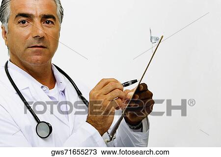 Portrait of a male doctor writing on a clipboard View Large Photo Image Stock Image - Portrait of a male doctor writing on a clipboard. Fotosearch