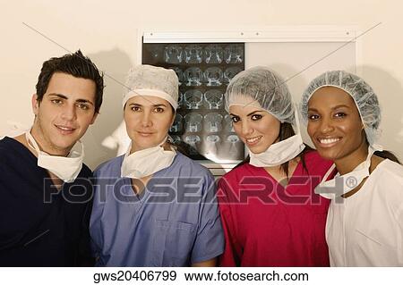 Portrait of a male surgeon and three female surgeons standing in front of an MRI scan View Large Photo Image Stock Photo - Portrait of a male surgeon and three female surgeons standing in front of an MRI scan. Fotosearch