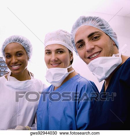 Portrait of a male surgeon and two female surgeons smiling View Large Photo Image Stock Image - Portrait of a male surgeon and two female surgeons smiling. Fotosearch