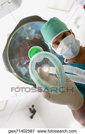 Portrait of a male surgeon holding an oxygen mask View Large Photo Image Stock Photo - Portrait of a male surgeon holding an oxygen mask. Fotosearch