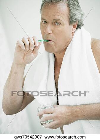 Portrait of a mature man brushing his teeth View Large Photo Image Stock Photo - Portrait of a mature man brushing his teeth. Fotosearch