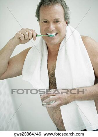 Portrait of a mature man brushing his teeth View Large Photo Image Stock Photograph - Portrait of a mature man brushing his teeth. Fotosearch