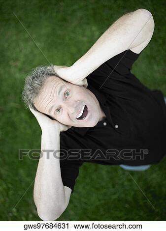 Portrait of a mature man covering his ears with his hands View Large Photo Image Stock Image - Portrait of a mature man covering his ears with his hands. Fotosearch