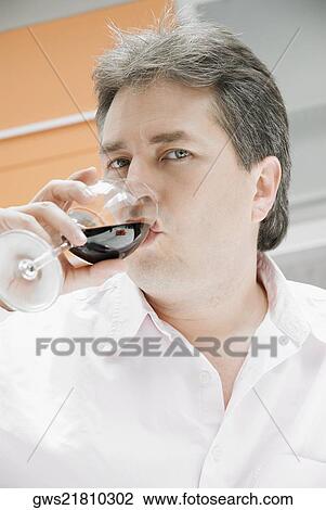 Portrait of a mature man drinking a glass of red wine View Large Photo Image Stock Image - Portrait of a mature man drinking a glass of red wine. Fotosearch