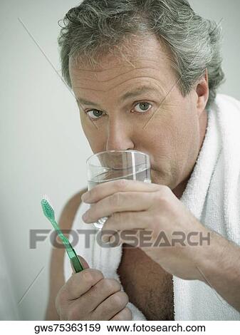 Stock Photo - Portrait of a mature man drinking water. Fotosearch