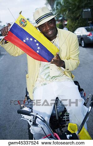 Portrait of a mature man holding a Venezuelan flag View Large Photo Image Picture - Portrait of a mature man holding a Venezuelan flag. Fotosearch
