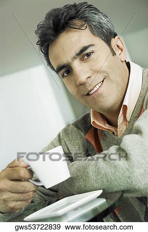 Portrait of a mature man holding a tea cup View Large Photo Image Stock Photo - Portrait of a mature man holding a tea cup. Fotosearch