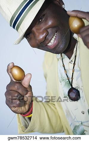 Portrait of a mature man holding two golden eggs View Large Photo Image Picture - Portrait of a mature man holding two golden eggs. Fotosearch