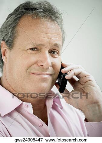 Stock Photo - Portrait of a mature man talking on a mobile phone. Fotosearch