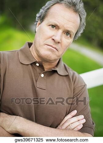 Portrait of a mature man with his arms crossed View Large Photo Image Stock Photography - Portrait of a mature man with his arms crossed. Fotosearch