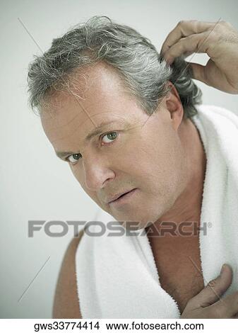 Portrait of a mature man with his hand in his hair View Large Photo Image Picture - Portrait of a mature man with his hand in his hair. Fotosearch