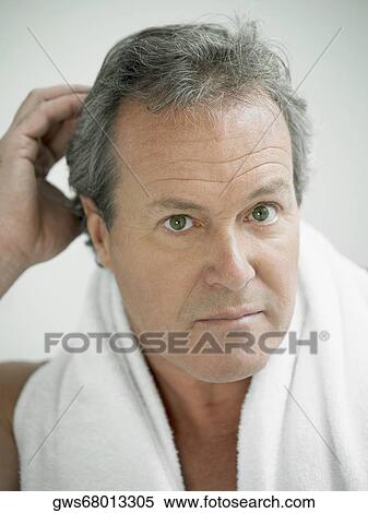 Portrait of a mature man with his hand in his hair View Large Photo Image Stock Photography - Portrait of a mature man with his hand in his hair. Fotosearch