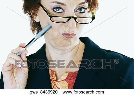 Portrait of a mature woman holding a pen View Large Photo Image Stock Image - Portrait of a mature woman holding a pen. Fotosearch