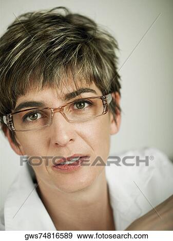 Stock Photo - Portrait of a mature woman wearing eyeglasses. Fotosearch