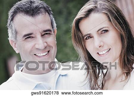 Portrait of a mid adult couple smiling View Large Photo Image Stock Photo - Portrait of a mid adult couple smiling. Fotosearch