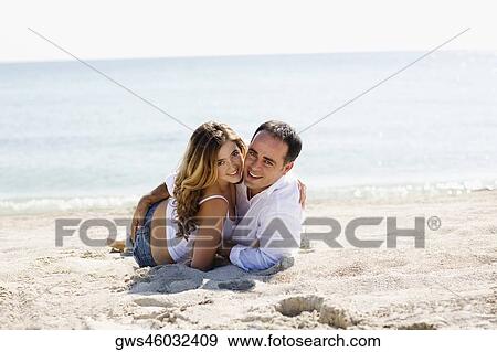 Portrait of a mid adult man and a young woman on the beach View Large Photo Image Stock Photo - Portrait of a mid adult man and a young woman on the beach. Fotosearch