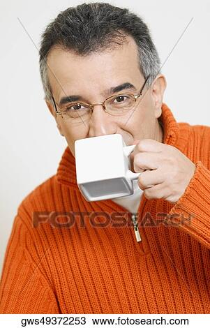 Portrait of a mid adult man drinking a cup of coffee View Large Photo Image Stock Image - Portrait of a mid adult man drinking a cup of coffee. Fotosearch
