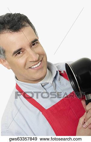 Portrait of a mid adult man holding a saucepan View Large Photo Image Stock Photo - Portrait of a mid adult man holding a saucepan. Fotosearch