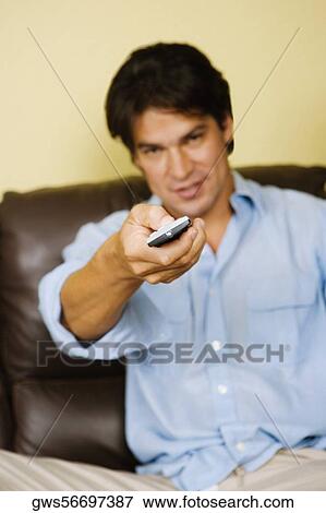 Portrait of a mid adult man operating a remote control View Large Photo Image Stock Photo - Portrait of a mid adult man operating a remote control. Fotosearch
