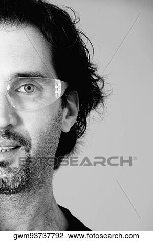 Portrait of a mid adult man wearing protective eyewear View Large Photo Image Stock Image - Portrait of a mid adult man wearing protective eyewear. Fotosearch