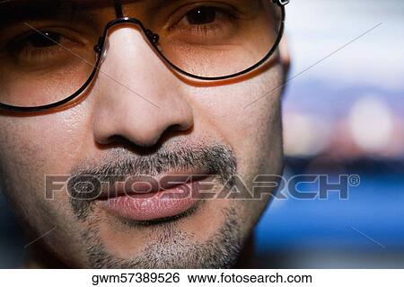 Portrait of a mid adult man wearing sunglasses View Large Photo Image Stock Photograph - Portrait of a mid adult man wearing sunglasses. Fotosearch