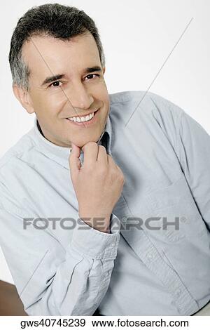 Portrait of a mid adult man with his hand on his chin View Large Photo Image Stock Photo - Portrait of a mid adult man with his hand on his chin. Fotosearch