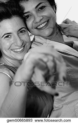 Portrait of a mid adult woman and a young woman pointing forward View Large Photo Image Stock Image - Portrait of a mid adult woman and a young woman pointing forward. Fotosearch