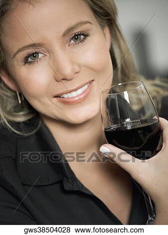 Portrait of a mid adult woman holding a glass of red wine View Large Photo Image Stock Photo - Portrait of a mid adult woman holding a glass of red wine. Fotosearch