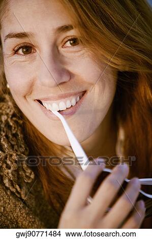 Portrait of a mid adult woman holding sunglasses View Large Photo Image Picture - Portrait of a mid adult woman holding sunglasses. Fotosearch