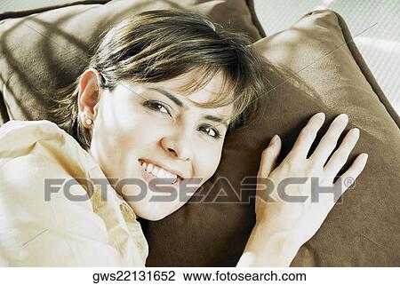 Portrait of a mid adult woman lying on the bed and smiling View Large Photo Image Stock Image - Portrait of a mid adult woman lying on the bed and smiling. Fotosearch
