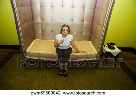 Portrait of a mid adult woman sitting in an armchair View Large Photo Image Stock Image - Portrait of a mid adult woman sitting in an armchair. Fotosearch