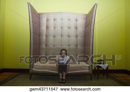 Portrait of a mid adult woman sitting in an armchair View Large Photo Image Stock Photo - Portrait of a mid adult woman sitting in an armchair. Fotosearch