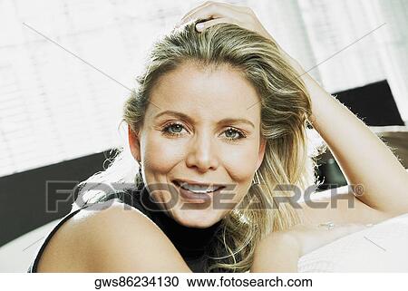Stock Image - Portrait of a mid adult woman smiling. Fotosearch